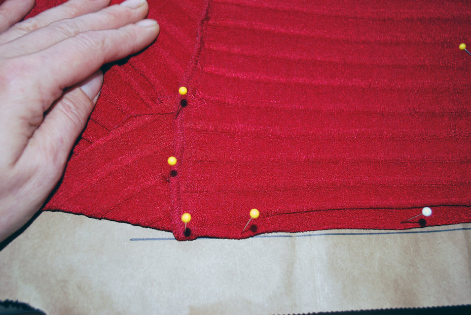 Pinning along the under bust seam line of the top, making sure to put pins to mark where the bust pieces overlap above the tummy panel.