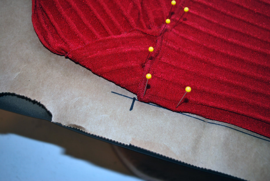 Drawing a cross hatch at the top of the tummy panel, right where the seam line starts.