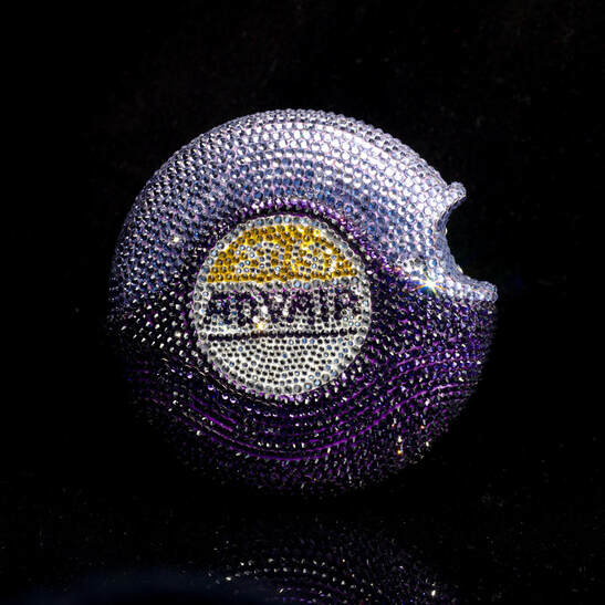 A purple rhinestone covered inhaler disc labeled Advair
