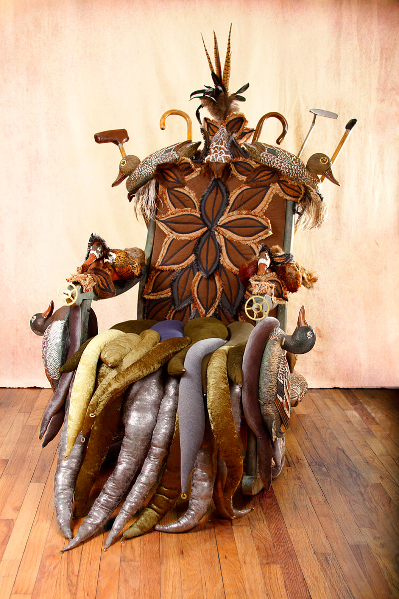 Front view of a rocking chair covered in duck decoys and feathers. The seat is made of padded wavelike tentacles.