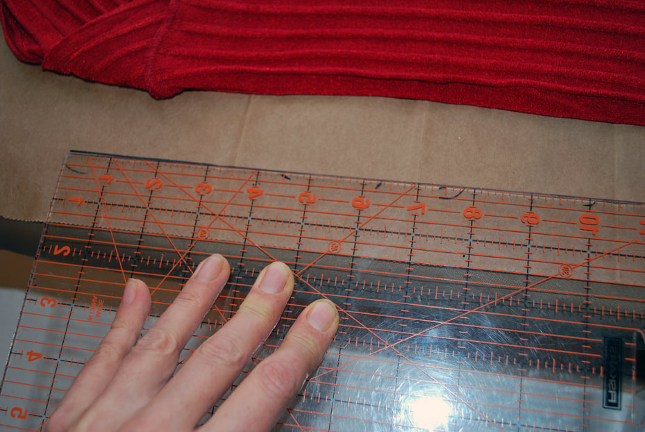 Using a ruler to draw out a straight line on the paper. This will become the front fold line.