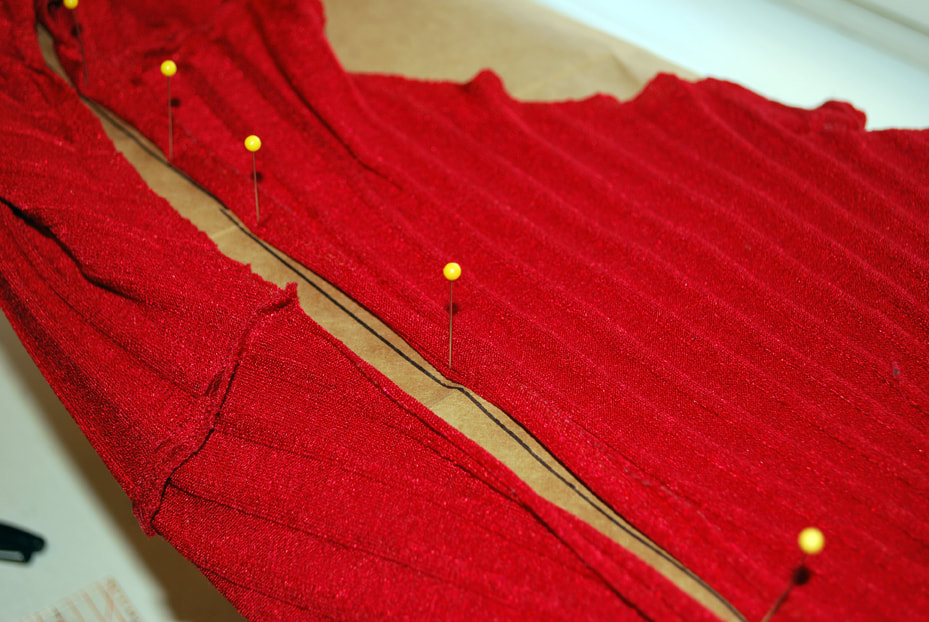 Pinning the  front edge along the line all the way up to the shoulder seam.