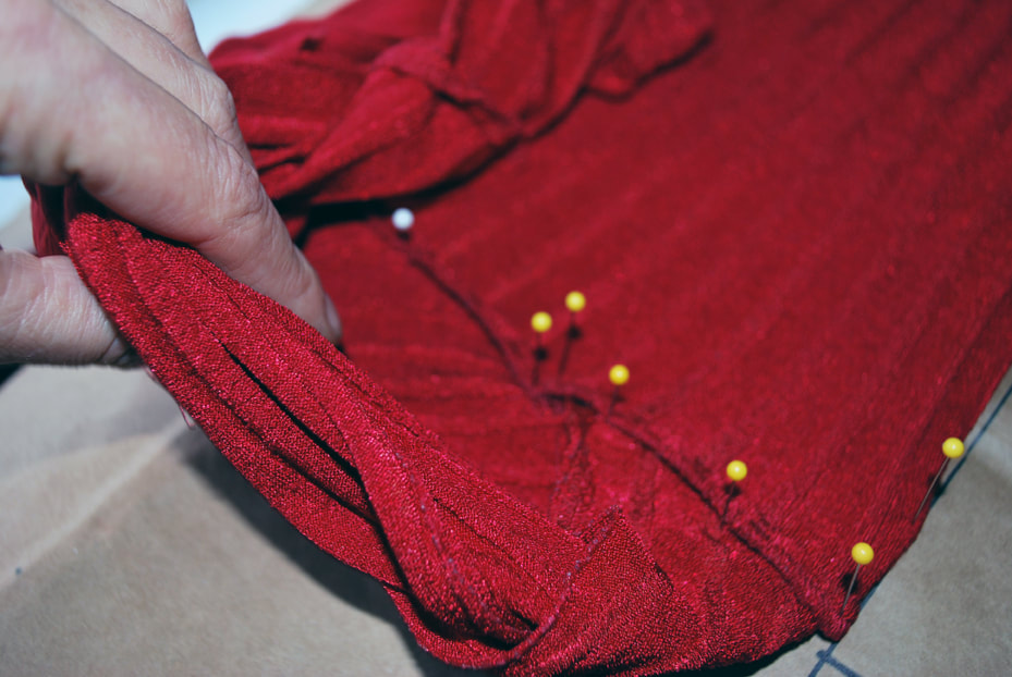 Double check the overlap mark by pulling the bust fabric back up and revealing the pins at the under bust seam.