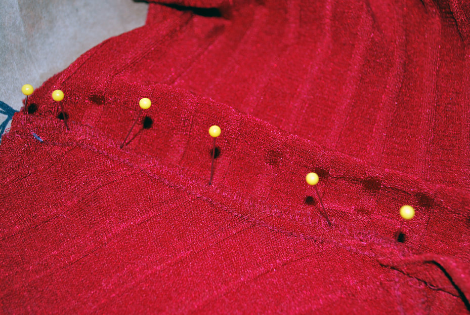 Pins in a row along the under bust line.