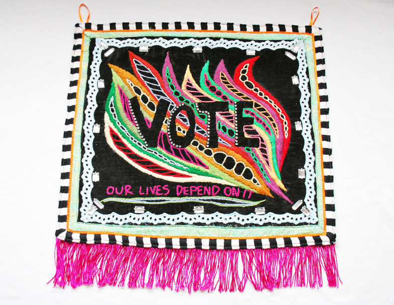 Colorful embroidered wave-like shapes on a black background outline the word VOTE. The words 